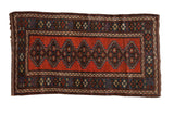 Antique Kurdish rug with interconnected diamond medallions on a madder red field framed by a cobalt blue border.