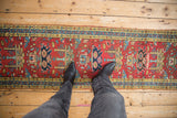 Vintage Heriz runner with repeating plant motifs, seed pearl borders on cherry red.