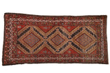 Vintage Hamadan rug with brick red field, triple stepped medallions, charcoal, and beige geometric patterns.