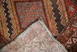 Corner of vintage Hamadan rug, revealing hand-knotted foundation, geometric pile, and selvage.
