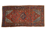 Vintage Heriz runner with triple diamond medallions, brick red field, and blue stepped spandrels.