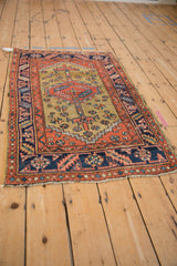 Angled perspective of an antique Heriz rug, showing its full geometric layout and proportions.