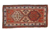 Antique Serab rug runner with double brick red and ivory germinating floral medallions.