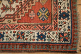 Antique Serab rug corner with germinating floral border, distinct pawn motif, and visible fringe.