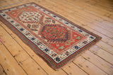 Antique Serab runner's reciprocating pawn border in brick red, navy, ivory. Shows even wear.