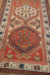 Antique Serab runner: brick red floral medallion, ivory vine, and reciprocating pawn borders.