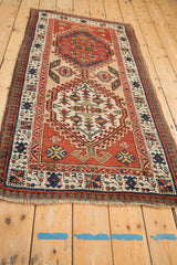Antique Serab runner corner: brick red reciprocating pawn border, ivory floral motifs.
