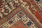 Antique Serab runner corner with brick red and navy floral patterns, fringe, and hand-knotted back.
