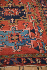 Close-up of the vintage Karaja rug's navy blue border pattern and secured fringe.