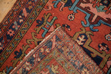 Brick red vintage Karaja rug with navy geometric border and hand-knotted foundation.