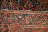 Detail of antique Farahan Sarouk rug's navy Herati border, adjacent to henna plant field.