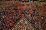 Antique Farahan Sarouk rug: inverted henna plant motif, ivory spandrel, navy field, Herati border.