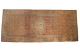 Distressed Malayer carpet with a concentric medallion, terracotta trellis field, and sky blue accents.
