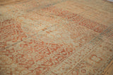 Angled view showing the even wear and terracotta trellis design on a fine Malayer carpet.