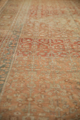 Low angle view showing the even wear and low pile texture of a distressed Malayer carpet.