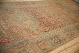 Low pile texture of a distressed Malayer carpet with terracotta and blue trellis motifs.