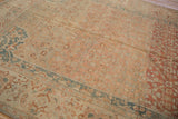 Angled view highlighting the time-softened tones and low-pile texture of a vintage Malayer carpet.