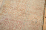 Fine, hand-knotted texture and even wear on a distressed Persian Malayer carpet.