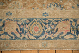 Worn border of an antique Khoy carpet, showing Safavid-inspired palmettes in dusty blue and blush.