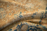 The soft, folded texture and low, even pile of a distressed antique Khoy carpet.