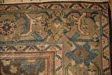 Low, worn pile texture on the floral border of a vintage distressed Mahal carpet corner.