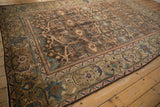 Angled view of a vintage Mahal carpet, showing its distressed texture and floral lattice.