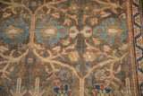 Close-up showing the even wear and low pile of the vintage Mahal's floral pattern.