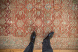 Close view of the distressed Mahal carpet's evenly worn pile and soft raspberry red floral pattern.