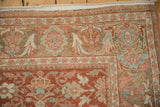 Detail of the distressed Mahal carpet's floral border in raspberry red, powder blue, and ivory tones.