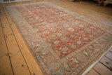 Softly distressed texture and even wear on a vintage Persian Mahal carpet's floral field.