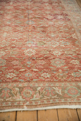 Low angle showing the even wear on a distressed Mahal carpet with raspberry and blue floral patterns.