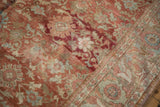 Close-up of the distressed Mahal carpet's low pile showing a floral motif with deep ruby red coloration.