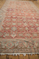 Low-angle view down the length of a distressed Mahal carpet, highlighting its worn texture and floral field.