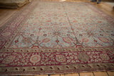Distressed powder blue field, Safavid palmettes, and rich burgundy floral border of the Yezd rug.