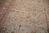 Distressed Persian Yezd carpet's Safavid palmette lattice, dusty blue, magenta, and red border.
