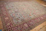 Burgundy wine red border on antique Yezd carpet with floral vines and side cord selvage.