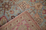 Folded corner of antique Yezd carpet, dusty blue palmettes, worn pile, foundation, and selvage.