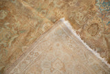 Vintage distressed Tabriz carpet corner showing worn gold wash pile and hand-knotted foundation.