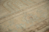 Textural detail of the distressed pile on a vintage Oushak rug, beige with pale blue.