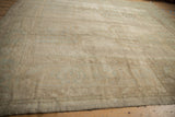 Distressed beige texture and faded powder blue patterns on a vintage Oushak rug.