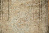 Distressed vintage Oushak carpet pile shows visible knot heads in antique ivory, sand, pale coffee.
