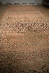 Lengthwise view of a distressed Malayer carpet showing heavy abrashes in blush and brown tones.