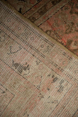 The hand-knotted foundation and secured selvage of a vintage Persian Malayer carpet.