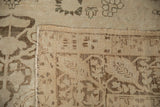 Hand knotted wool pile of antique Kerman carpet with visible foundation and tattered edge.