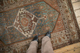 Distressed Vintage Hamadan rug: hexagonal medallion, finned palmettes, abrashed dusty blue and terracotta field.
