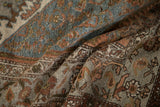 Distressed vintage Hamadan rug pile with faded dusty blue, terracotta, and subtle floral motifs.