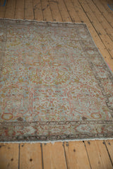 Muted Gol Ferang floral design and softened pile on the distressed Sarouk rug.