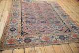Antique Malayer rug corner, showing blush and navy floral cross-section border motif.