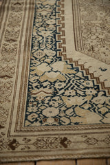 Evenly worn pile of an antique Malayer rug showing the navy floral and geometric border.