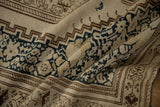 Tactile low-pile weave and floral blossom border of a distressed antique Persian Malayer rug.